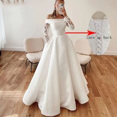 a woman in a white wedding dress is taking a selfie