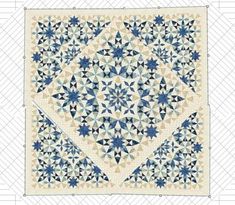 a blue and white quilt with an intricate design on the front, in two rows