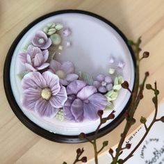 there are flowers in the bowl on the table