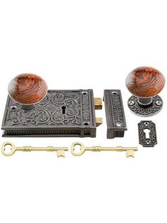 an antique style door handle with two knobs and keyhole, set on a white background