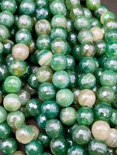 green and white beads sitting on top of each other