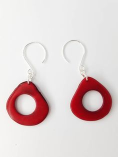 These very light earrings are a breeze to wear. Lots of movement and a splash of color from these natural tagua hoops. Sterling silver findings and top quality tagua beads are used for a lifetime of enjoyment! I hand match and dye these earrings. Any color is possible. Please see my other listings for red tones and nuetrals. If you don't see the perfect color just let me know. Red Teardrop Jewelry For The Beach, Red Round Earrings For Beach, Red Teardrop Earrings For The Beach, Red Teardrop Earrings For Beach, Handmade Red Plastic Earrings, Red Round Beach Earrings, Red Round Metal Earrings, Playful Nickel-free Red Earrings, 14th Anniversary Gifts