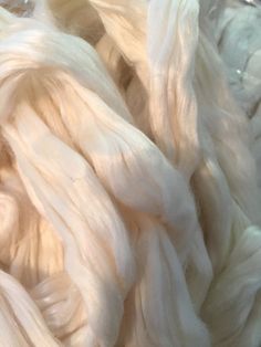 white yarn is piled up in a pile