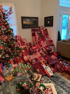 a christmas tree is covered with presents and candy canes