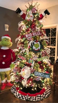 the grinch christmas tree is decorated in red and green