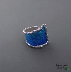 "The sweetness of calming blues, an ocean of life wrapped around your finger, Jewelersoul's contemporary Wrap Wave Ring is coated with layers of blue enamel over sterling silver. The modern ring is for true ocean lovers. Please note that Jewelersoul's unique handmade process may result in subtle variations in color and metal growth. Details: Weight: 8.2 g Width: 24 mm = 0.94\" Size US Available: 7 3/4\" US. Other sizes: please tell me and I would make the you size ring. Follow me www.facebook.co Blue Enamel Open Ring Jewelry, Blue Sterling Silver Fusion Rings, Fusion Style Blue Sterling Silver Rings, Modern Blue Jewelry With Unique Variations, Unique Blue Enamel Ring, Blue Fusion Style Rings As A Gift, Wide Silver Ring, Summer Rings, Handmade Silver Jewelry