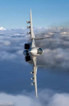 an airplane is flying high above the clouds