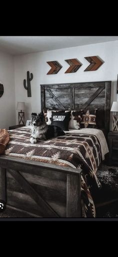 a cat sitting on top of a bed in a room with wooden furniture and decor