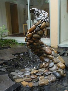 a fountain made out of rocks and water