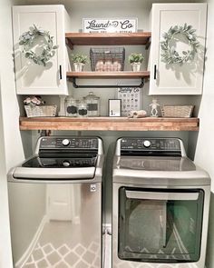 a washer and dryer in a small room with shelves above the washer