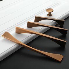 three pieces of wood sitting on top of a window sill next to a white door