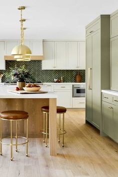 a kitchen with an island and stools in it