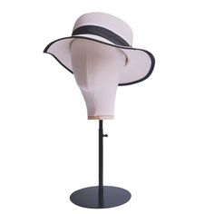 a white hat on a black stand