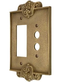 an ornate light switch plate cover with two holes in the front and one on the back