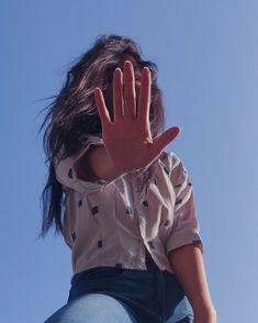 a woman with her hand up in the air