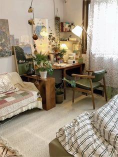 a bedroom with a bed, desk and chair in it's center area next to a window