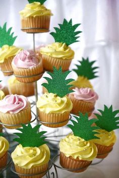 there are cupcakes with pineapple decorations on them