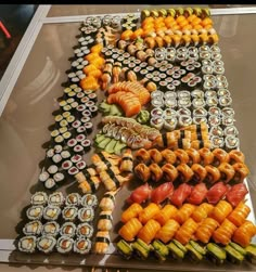 an assortment of sushi on display in a glass case