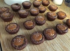 chocolate cupcakes with peanut butter frosting on a cutting board