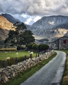 an old stone house on the side of a country road