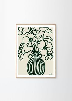 a green and white vase with flowers in it