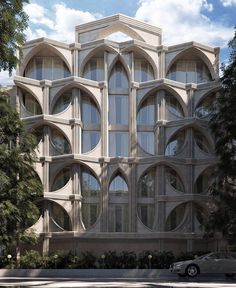 a large white building with many windows on it's side and cars parked in front