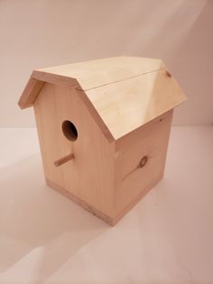 a wooden bird house on a white background