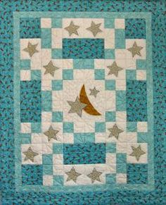 a blue and white quilt with silver stars on the top, and a brown bird in the middle