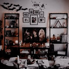 a living room decorated for halloween with pictures on the wall