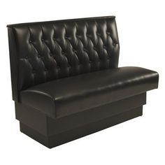 a black leather couch sitting on top of a wooden table