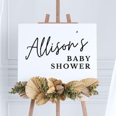 a sign that says, allison's baby shower on it with flowers around it