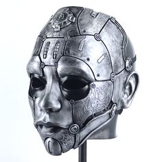 a metal mask with gears on it's face is shown in front of a white background