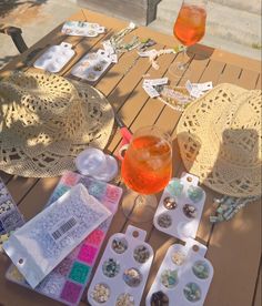 a table topped with lots of different items on top of a wooden table covered in paper