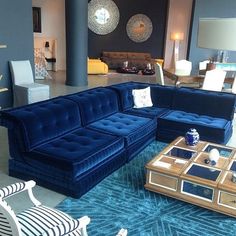 a living room filled with blue couches and chairs