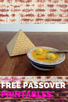 a bowl of soup with lemons in front of a pyramid and text that reads free passover printables