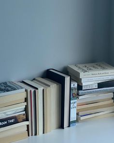 a stack of books sitting on top of a white table