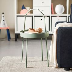 a living room scene with focus on the foot rest and shoe rack in the corner