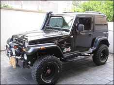 a black jeep parked in front of a building