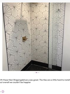 the shower is decorated with black and white tiles