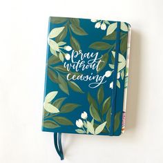 a blue notebook with green leaves and the words sorry without ceasing written on it