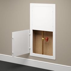 an open white cabinet with a red object in it