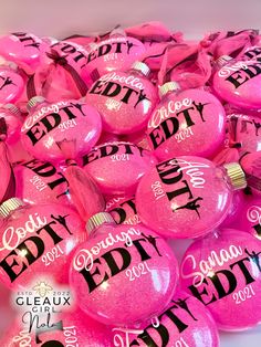 pink balloons with black letters and names on them