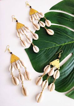 "Cowrie Shell Dangle Earrings, Bohemian, Ethnic, African Jewelry You wish to look brilliant. And now you can. Cowrie shells and brass, 4.5\" length, 14 shells total. Still shopping? Great. www.KheperaAdornments.etsy.com" Cowrie Shells, Earrings Bohemian, African Jewelry, Cowrie Shell, And Now, Arrow Necklace, To Look, Dangle Drop Earrings, Shells