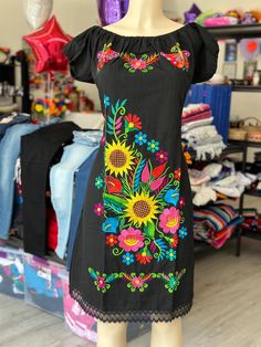 100% Authentic Mexican Dress  This Dress is gorgeous. Once size fit up to XL Color: Black  Size: XL It has elastic an the back of the dress  the floral wall remain the same but the embroidery colors vary on each dress Ebroidery Mexican Dress.Boho Chic Dress Folk Fabric Flowers Mexican Tunic Traditional Embroidery This Dress is perfect for those beach day or any occasion This Dress is meant to provide extreme comfort throughout the day The perfect gift for her Fitted Black Cotton Embroidered Dress, Black Fitted Cotton Embroidered Dress, Fitted Cotton Embroidered Black Dress, Black Embroidered Cotton Dresses, Black Cotton Dress With Embroidery, Black Embroidered Knee-length Summer Dress, Black Knee-length Embroidered Summer Dress, Black Cotton Dress With Floral Embroidery, Black Cotton Embroidered Dress With Floral Embroidery