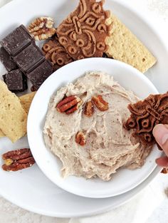 a white plate topped with desserts and crackers