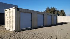 several storage units are lined up in the dirt