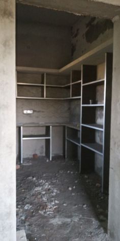 an empty room with shelves in it