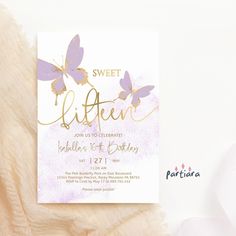 the sweet little butterfly birthday party is set on top of a fluffy white blanket with gold foil