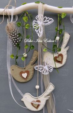 some white and brown decorations hanging from a branch