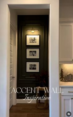 an open door leading into a kitchen with pictures on the wall